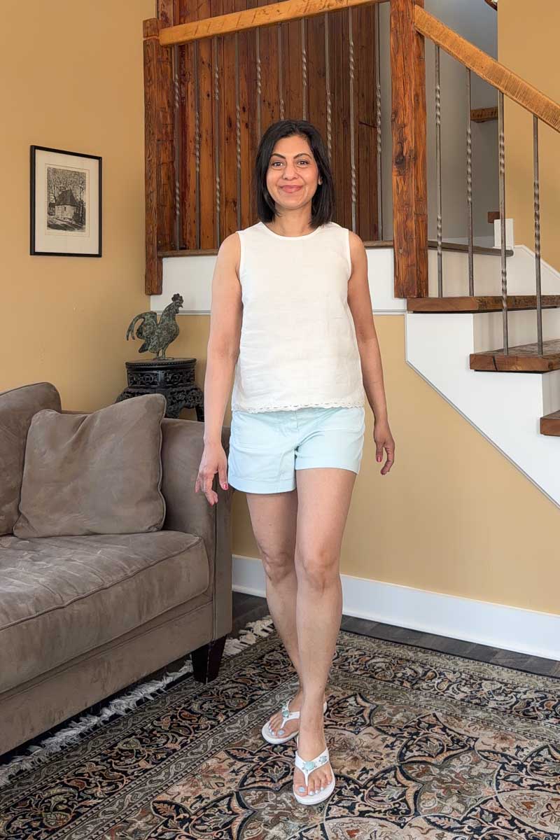 Fashionipa (Nipa) wearing an ivory linen top with scalloped border over blue shorts