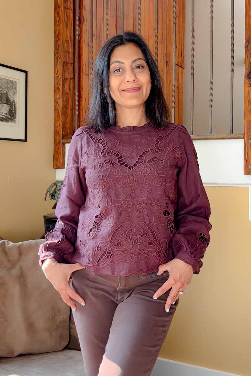 Fashionipa (Nipa) wearing a burgundy blouse with embroidery.
