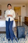 Fashionipa (Nipa) wearing a tan jacket, white tee, blue athletci pants and blue sneakers.