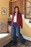 Fashionipa (Nipa) wearing a white t-shirt, jeans, a sweater jacket and Chelsea boots.