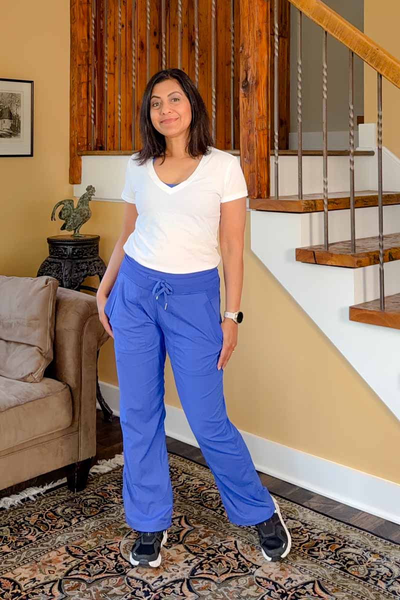Fashionipa (Nipa) wearing a white v-neck t-shirt, blue athletic pants and black sneakers.  