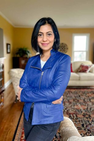 Fashionipa (Nipa) wearing a blue moto jacket, white v-neck t-shirt, and black jeans.