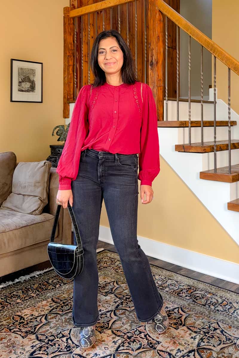 Fashionipa (Nipa) wearing a red blouse with cutout details, with black jeans and snakeskin boots.