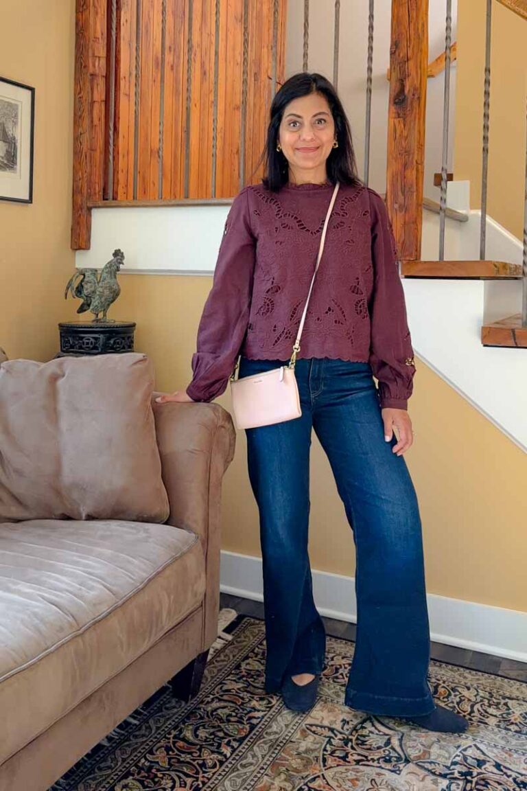 Fashionipa (Nipa) wearing a burgundy top, wide leg jeans, ballet flats and a crossbody handbag.